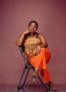 confident woman in stylish outfit sitting on chair